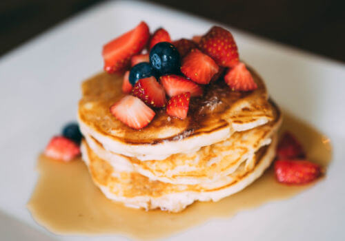 Banana Pancakes with Strawberries on white plate